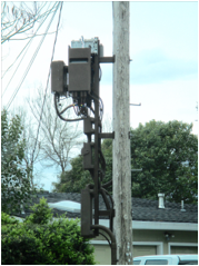 A telephone pole with wires attached

Description automatically generated
